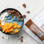 Smoothie bowl with mango, coconut, and granola