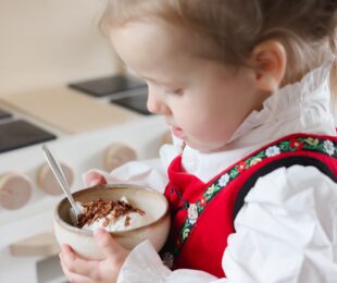 Kid holding a vanilla oat ice cream